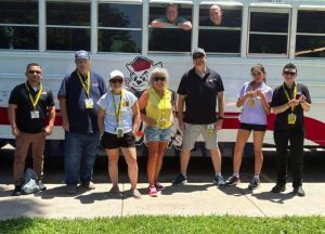 Bravo Mic Communications staff members at the Stuff the Bus Deming 2026 community event.