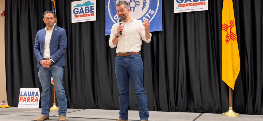 Pete Buttigieg speaks as U.S. Rep. Gabe Vasquez looks on during a campaign event at the Mimbres Valley Learning Center in Deming.