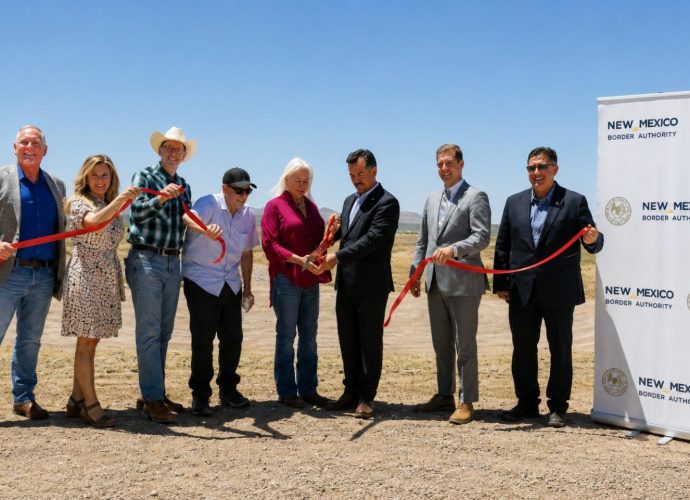 Alt Text: Officials participate in a ribbon-cutting ceremony celebrating completion of Phase 3 of the Southern New Mexico Berm Project in Columbus, New Mexico.