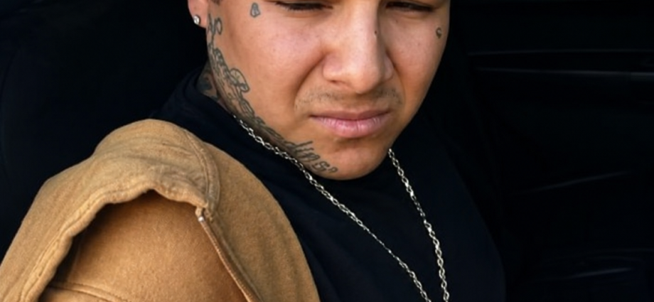 Raymond Garcia sits inside a law enforcement vehicle after being arrested by New Mexico State Police on a California murder warrant.
