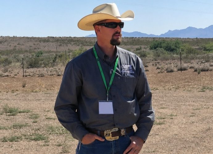 Russell Johnson, president of the Luna County Farm and Livestock Bureau, stands in the New Mexico desert during a public meeting discussing concerns over federal groundwater wells associated with border wall construction.