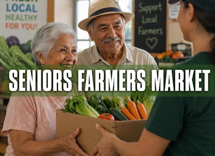 Older couple receiving a box filled with fresh vegetables at a farmers market.