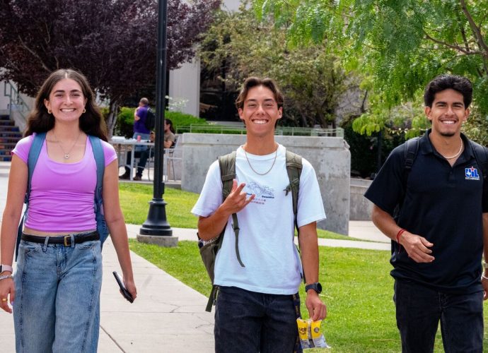 Three Western New Mexico University students walk across the Silver City campus during the first week of Fall 2026 classes.